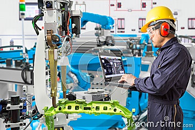 Engineer using computer maintenance automatic robotic industry Stock Photo