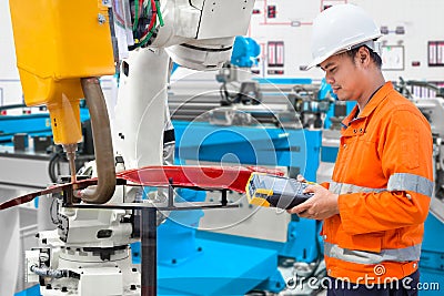 Engineer using laptop computer maintenance robot grip automotive workpiece, Industry 4.0 concept Stock Photo