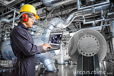 Engineer using laptop computer in thermal power plant factory Stock Photo