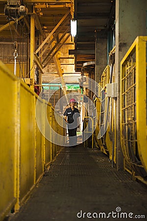 Engineer walking to check machine in factory. Editorial Stock Photo