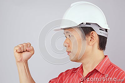 Engineer wear red shirt and white hat make signal fist Stock Photo