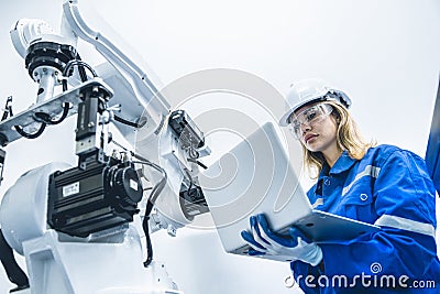 engineer woman worker working with robotic arm in productions lab research industry factory Stock Photo