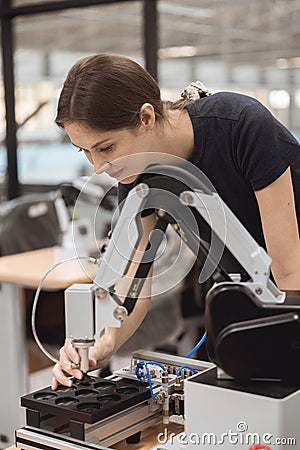 Engineer women learning education in Industrial Robotics program with robot arm simulation model in university engineering lab Stock Photo