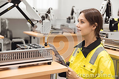 Engineer women learning education in Industrial Robotics program with robot arm simulation model in university engineering lab Stock Photo