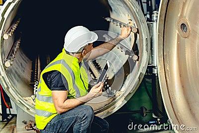 Engineer work service checking and maintenance industry boiler in heavy factory Stock Photo