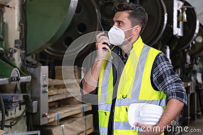 Engineer or worker wearing safety jackets, holding a helmet, and using walkie-talkie and talk to other staff. Working at Stock Photo