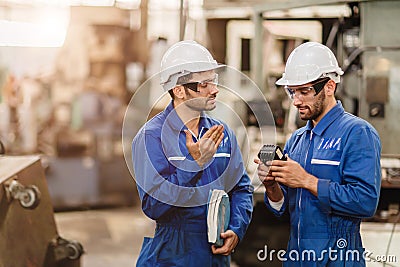 Engineer Worker Working Together Talking With Friend Teammate In Metal Factory Training Using Machine Part Stock Photo