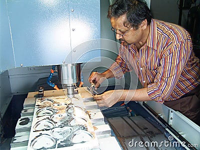 Engineer working on CNC machine Stock Photo
