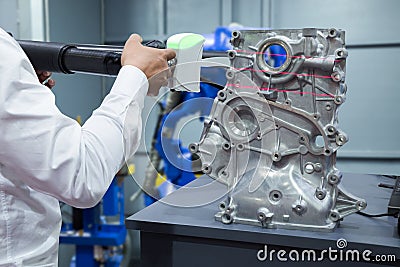 Engineer working with 3D portable measuring scan automotive part Stock Photo