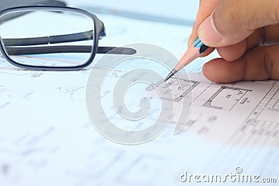 Engineer working on engineering drawing for a project. Stock Photo