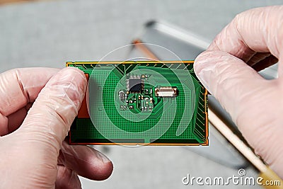 An engineer working on repairing a microchip in a tech laboratory Stock Photo