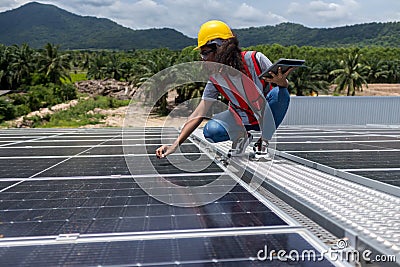 Engineer working setup Solar panel at the roof top. Engineer or worker work on solar panels or solar cells on the roof of business Stock Photo