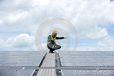 Engineer working setup Solar panel at the roof top. Engineer or worker work on solar panels or solar cells on the roof of business Stock Photo