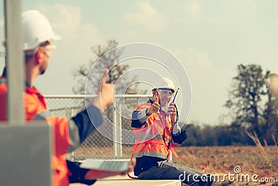 Engineer working at a wind farm for renewable energy has the responsibility of maintaining a sizable wind turbine. Encourage one Stock Photo