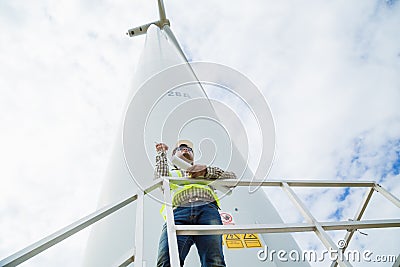 Engineer working at wind turbine site with blueprint Stock Photo