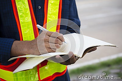 Engineer write take note on book for planing work Stock Photo