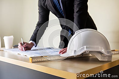 Engineer writing plan on blueprint paper Stock Photo