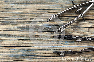 Engineering dividers tools on wood table Stock Photo