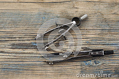 Engineering dividers tools on wood table Stock Photo