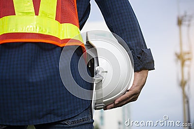 Engineering holds white safety hats and electric pole background Stock Photo