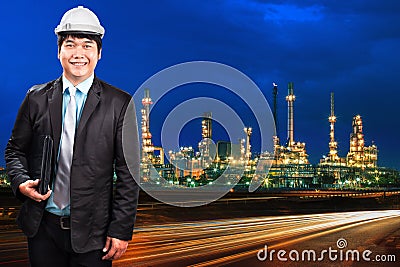Engineering man and oil refinery plant against beautiful blue du Stock Photo