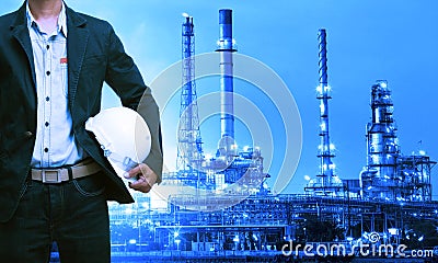 Engineering man and safety helmet standing against oil refinery Stock Photo