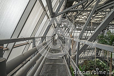 Engineering metal structures of the frame of the greenhouse, view from the technological bridge Editorial Stock Photo