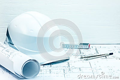 engineering project plans, blueprints, protective helmet, folding ruler and compasses on table Stock Photo