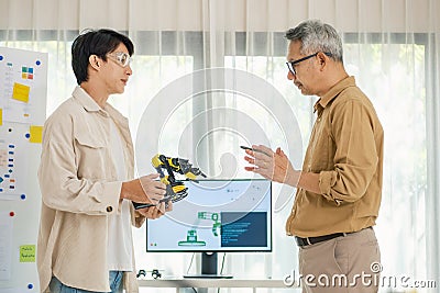 engineering robot technology with asian programmer innovation and research teamwork in coding development Stock Photo