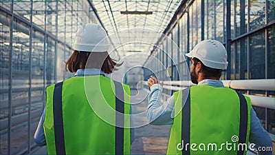 Engineering supervisors examining factory analysing data discussing safety Stock Photo