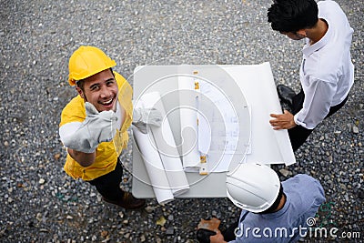 Engineering team look paper plans by top view Stock Photo