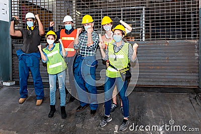 Engineering and technicians group Wearing a mask Standing front to the industrial factory which was shut down Stock Photo