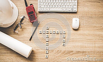 Engineering tools on work table for construction project with a white helmet, radio and blueprints. Words of engineer concepts col Stock Photo