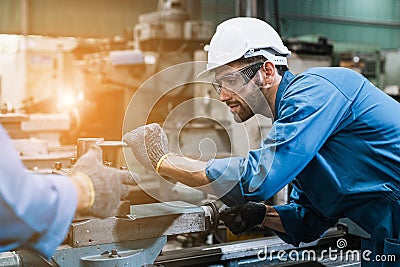 Engineering worker man wearing uniform safety and hardhat working machine lathe metal in factory industrial, worker manufactory Stock Photo
