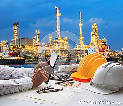 Engineering working on computer tablet against beautiful oil re Stock Photo