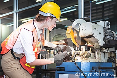 Engineers Caucasian woman are working using steel cutting machines Stock Photo