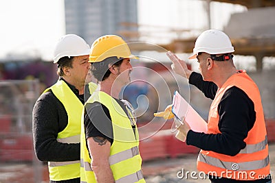 Engineers and construction workers at work Stock Photo