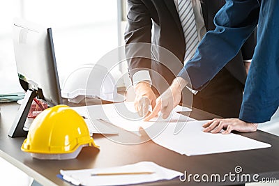 Asian engineers discuss about blueprint Stock Photo