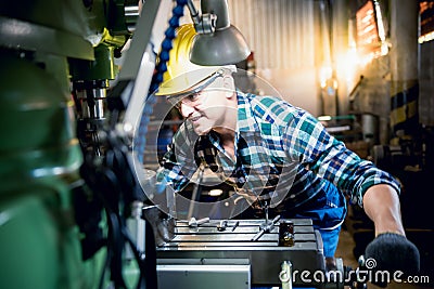 Engineers Caucasian man are working by controlling steel lathes Stock Photo
