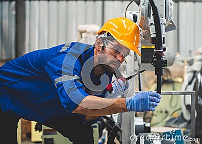 Engineers mechanic using computer controller Robotic arm for welding steel in steel factory workshop. Industry robot programming Stock Photo