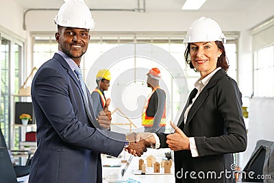 Engineers partnership business shake hands and thumb up gesture to joy successful agreement in engineering, Architectural or etc Stock Photo