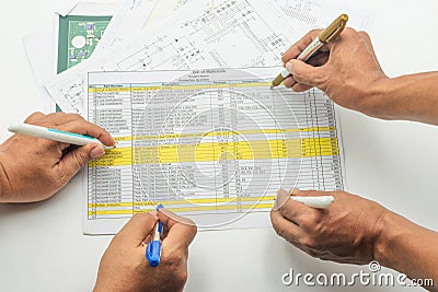 Engineer team assesses bill of material with detailed documentation and collaborative effort Stock Photo