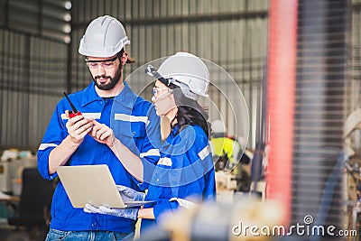 Engineers team mechanic using computer controller Robotic arm for welding steel in steel factory workshop. Industry robot Stock Photo