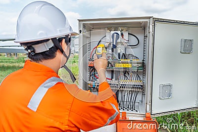 Engineers used a Thermo gun for checking the temperature of the equipment to confirming systems working normally. Concepts Stock Photo