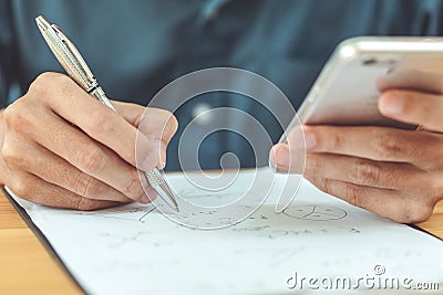 Engineers using a pen recorded data on the desk Stock Photo