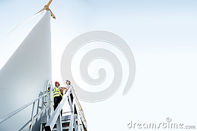 Engineers and wind turbines. Stock Photo