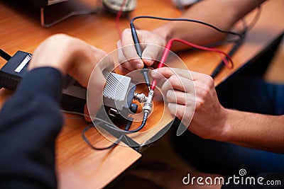 Engineers work with electrical measuring devices. Stock Photo