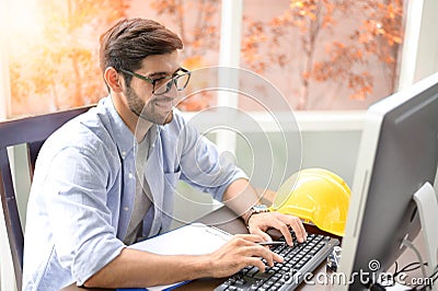 Engineers working within an office using a computer. Stock Photo