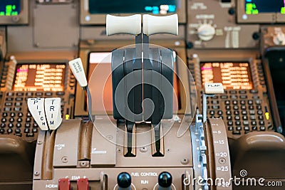 Engines thrust levers inside a big jet plane Stock Photo