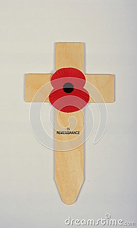 A single red poppy on a small wooden cross. Editorial Stock Photo